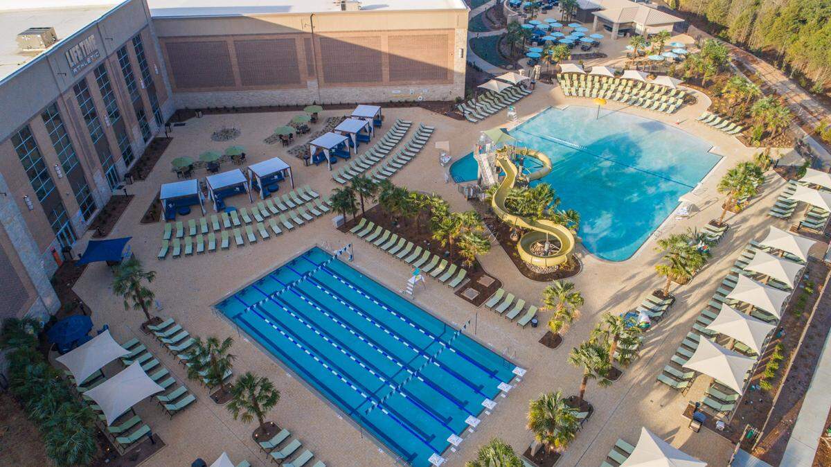 Life Time Charlotte offers both indoor and outdoor pools stacked with lounge space. All are heated except for the family pool with the slide.