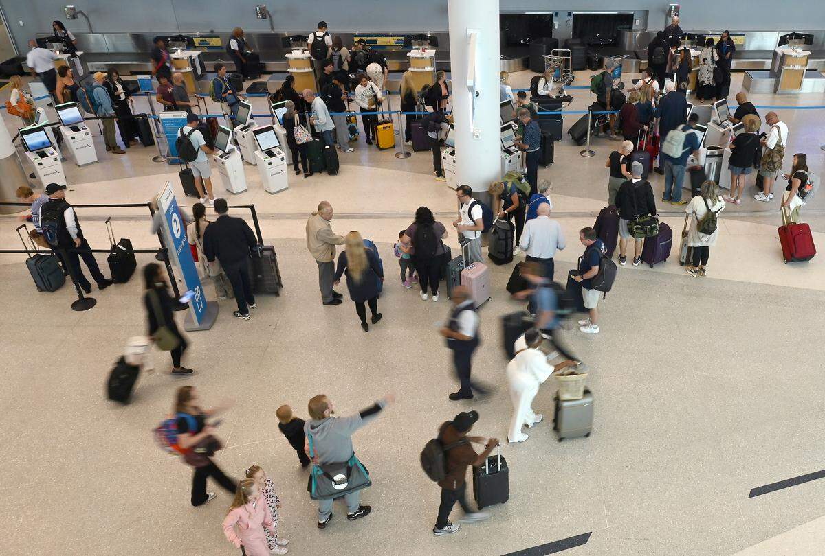 Travelers check in and drop their luggage at the Charlotte airport on Wednesday, Sept. 17, 2025. The airport saw 58.8 million travelers in 2024 with 18 million customers using the terminal lobby for arrivals and departures.