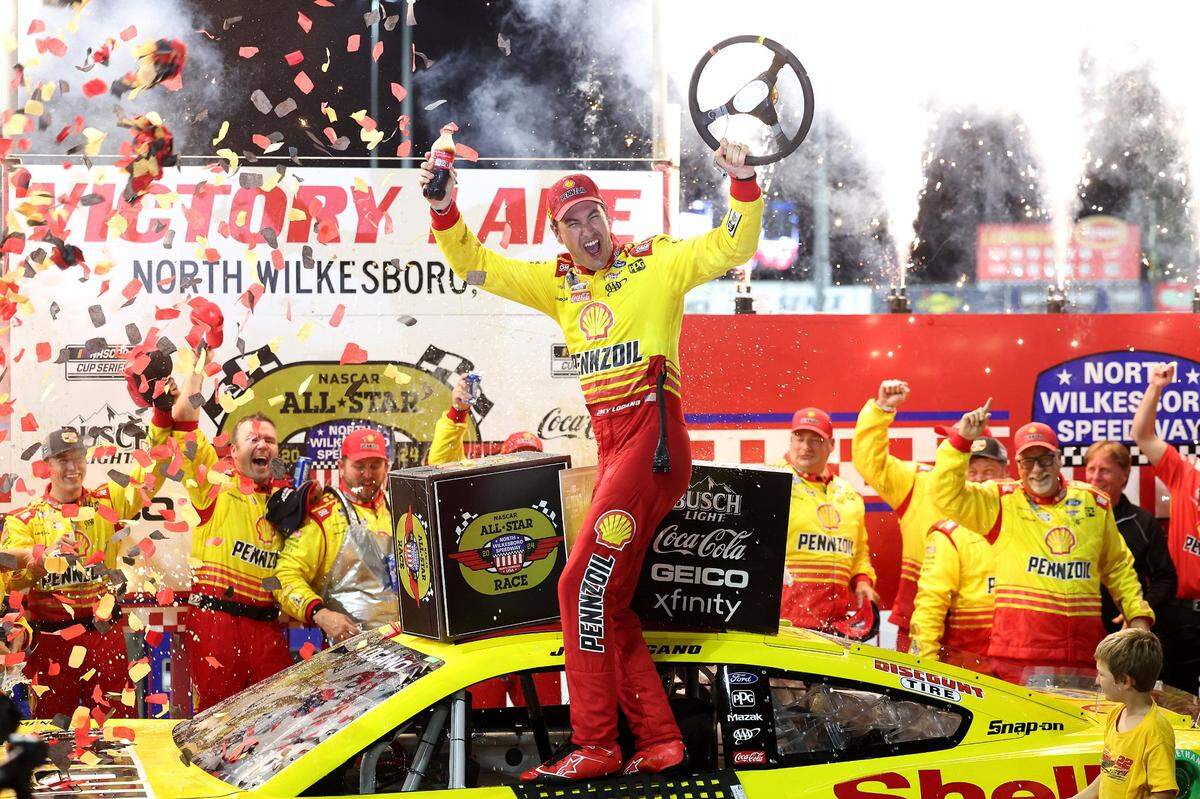 NASCAR Cup Series driver Joey Logano and his team celebrate winning the NASCAR All-Star race at North Wilkesboro Speedway in North Wilkesboro on Sunday, May 19, 2024.