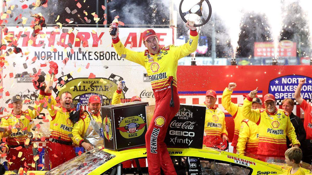NASCAR Cup Series driver Joey Logano and his team celebrate winning the NASCAR All-Star race at North Wilkesboro Speedway in North Wilkesboro on Sunday, May 19, 2024.