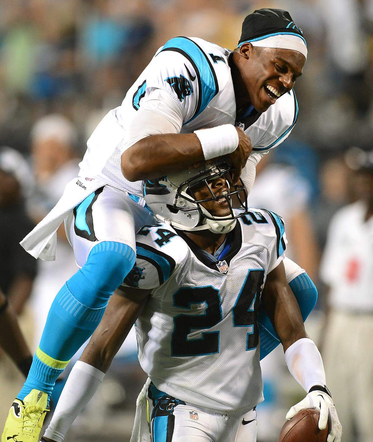 Carolina Panthers (1) quarterback Cam Newton leaps onto (24) cornerback Josh Norman’s back after Norman intercepted a pass by Steelers (3) quarterback Landry Jones during an Aug. 29, 2013 game at Bank of America Stadium.