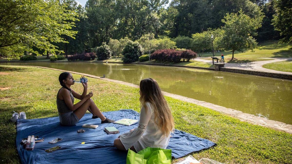 Aniyah Buckner, left and Stella Ervin sit at Freedom Park in Charlotte, N.C., on Monday, May 24, 2021.