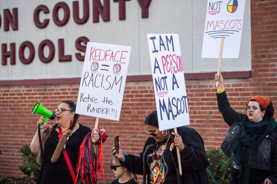 Becky Gaither, left, of the Cowichan Tribe, leads a chant alongside her granddaughter, Priscilla White, 6, and daughter, Angelea White, of the Puyallup Tribe, during a rally held by the Retire the Red Raider coalition and Metrolina Native American Association prior to a Gaston County Schools board meeting on Monday, November, 15, 2021 in Gastonia, NC. Since June 2020, the board has ignored outreach and public comment during school board meetings from students, teachers, alumni, and tribal leaders, who have shared concerns about the South Point Red Raider mascot and how it negatively depicts Native Americans.