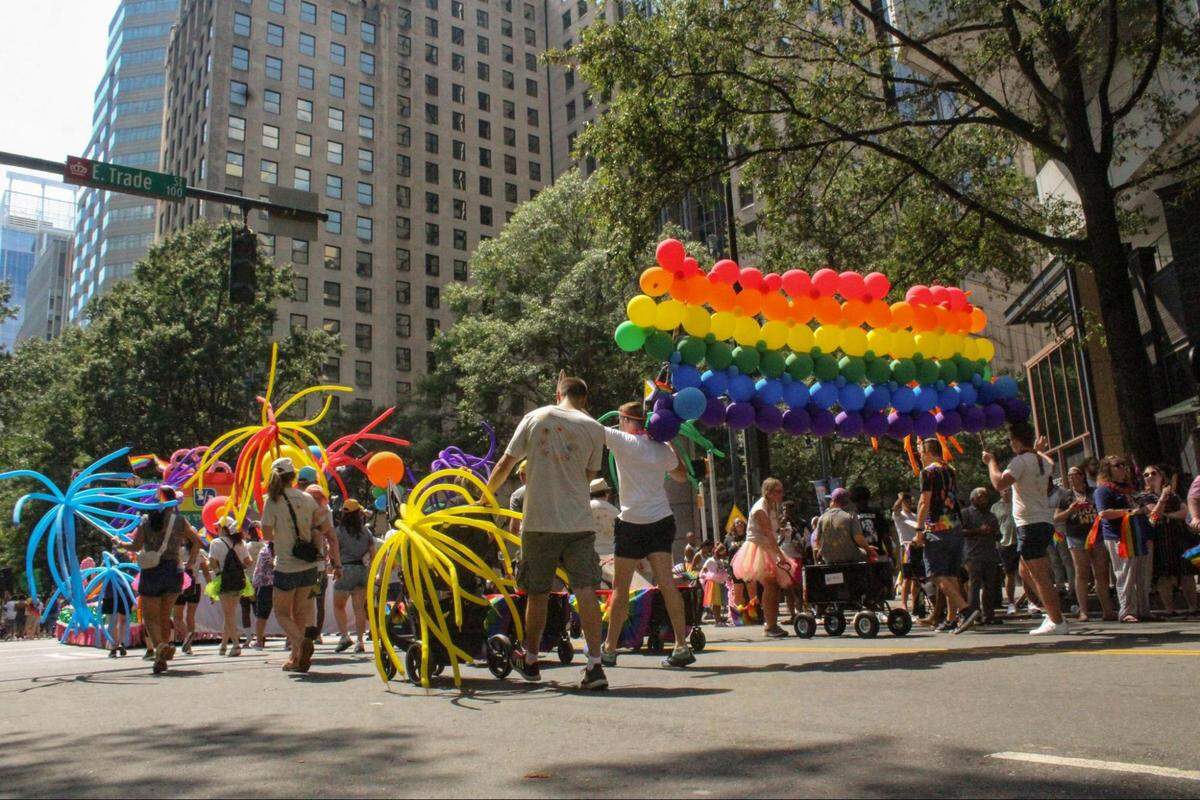 Paradegoers showcasea variety of vibrant and colorful balloons as part of the 2023 Charlotte Pride Parade.