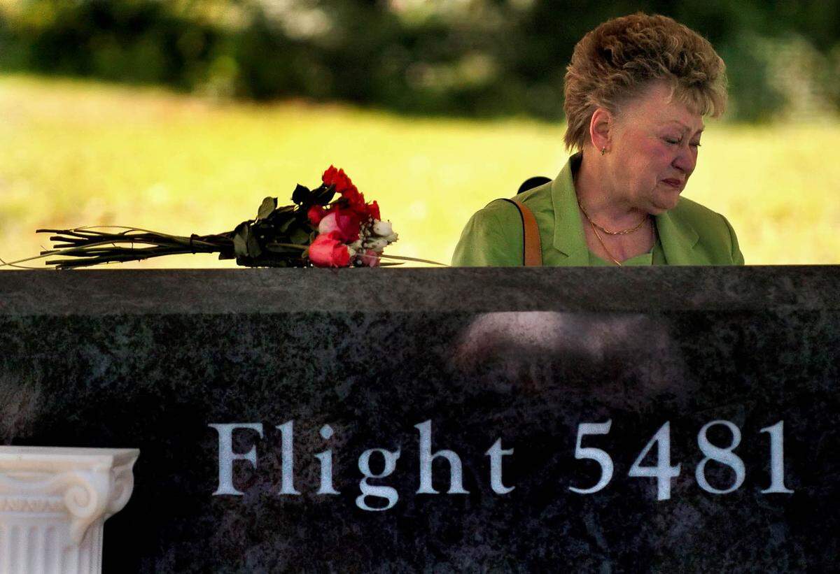 Annette Gezzer, whose son Gary was killed in the Air Midwest Flight 5481 crash, weeps beside marker for the victims at Charlotte Douglas International Airport. The crash killed 21 people.