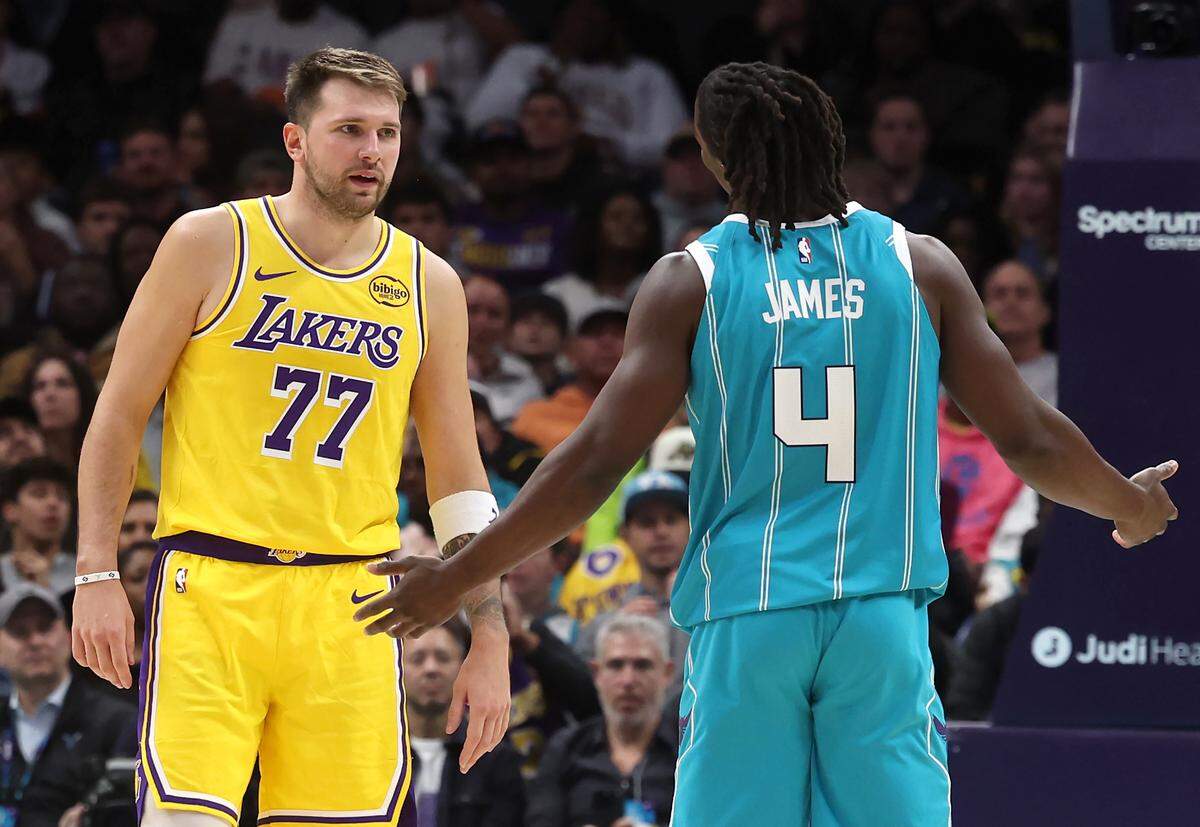 Los Angeles Lakers guard Luka Doncic, left and Charlotte Hornets guard Sion James, right, have a discussion about James’ defense during action on Monday at Spectrum Center. The Lakers defeated the Hornets 121-111.