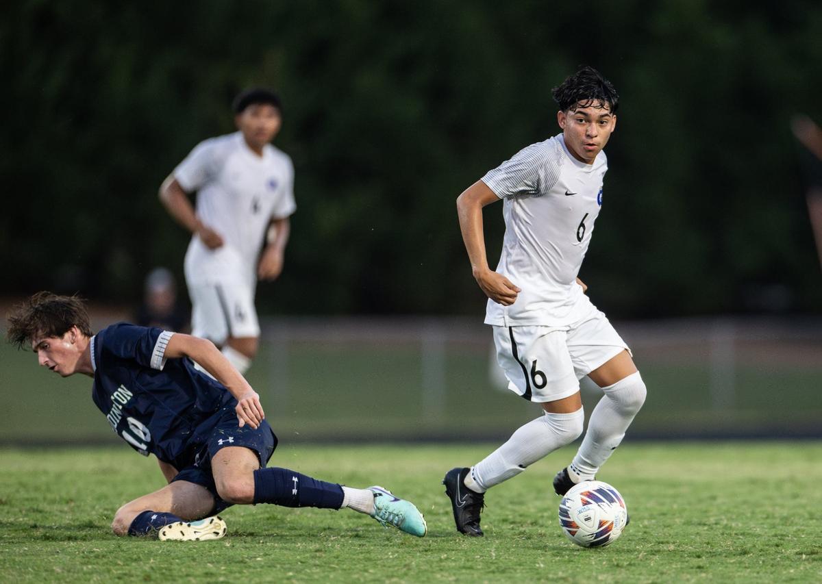 Garinger Wildcats Braian Velasquez, right, controls the ball past Weddington Warriors Pierce Cooper at Weddington High School in Matthews, N.C., on Wednesday, August 28, 2024.