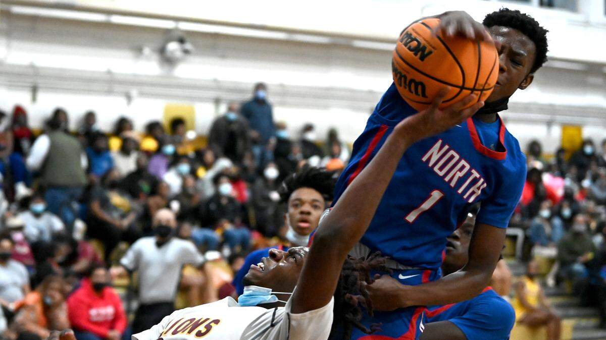 West Charlotte Lions Landon King, left, has his shot blocked by North MeckÕs Davion Cunningham during first half action on Friday, January 14, 2022 at West Charlotte High School.