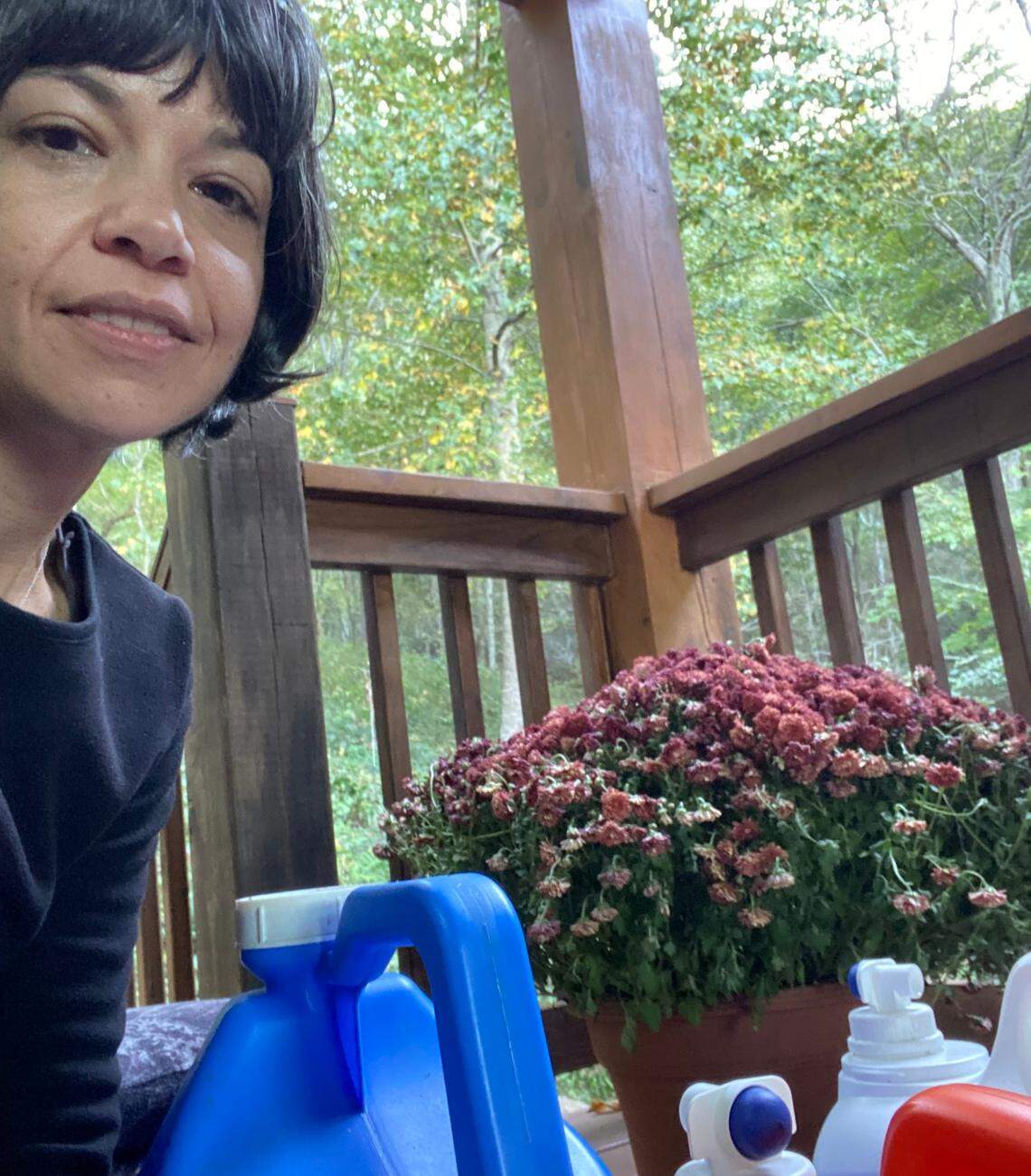 Sara Murphy takes a selfie with the water jugs her family hauled to a nearby creek to fill for washing and toilet flushing.