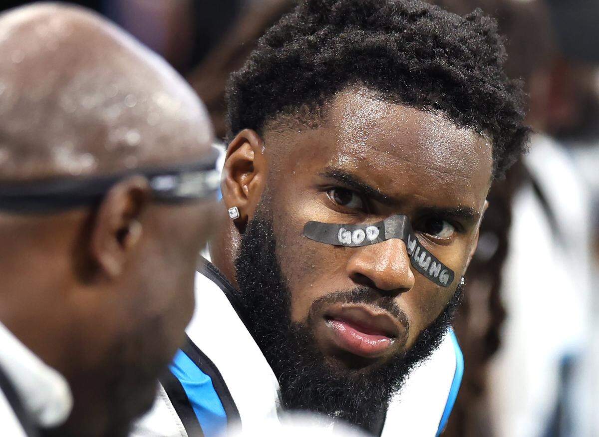 Carolina Panthers linebacker Brian Burns listens to a teammate on the sideline during action against the Atlanta Falcons at Mercedes-Benz Stadium in Atlanta, GA on Sunday, September 10, 2023. The Falcons defeated the Panthers 24-10.