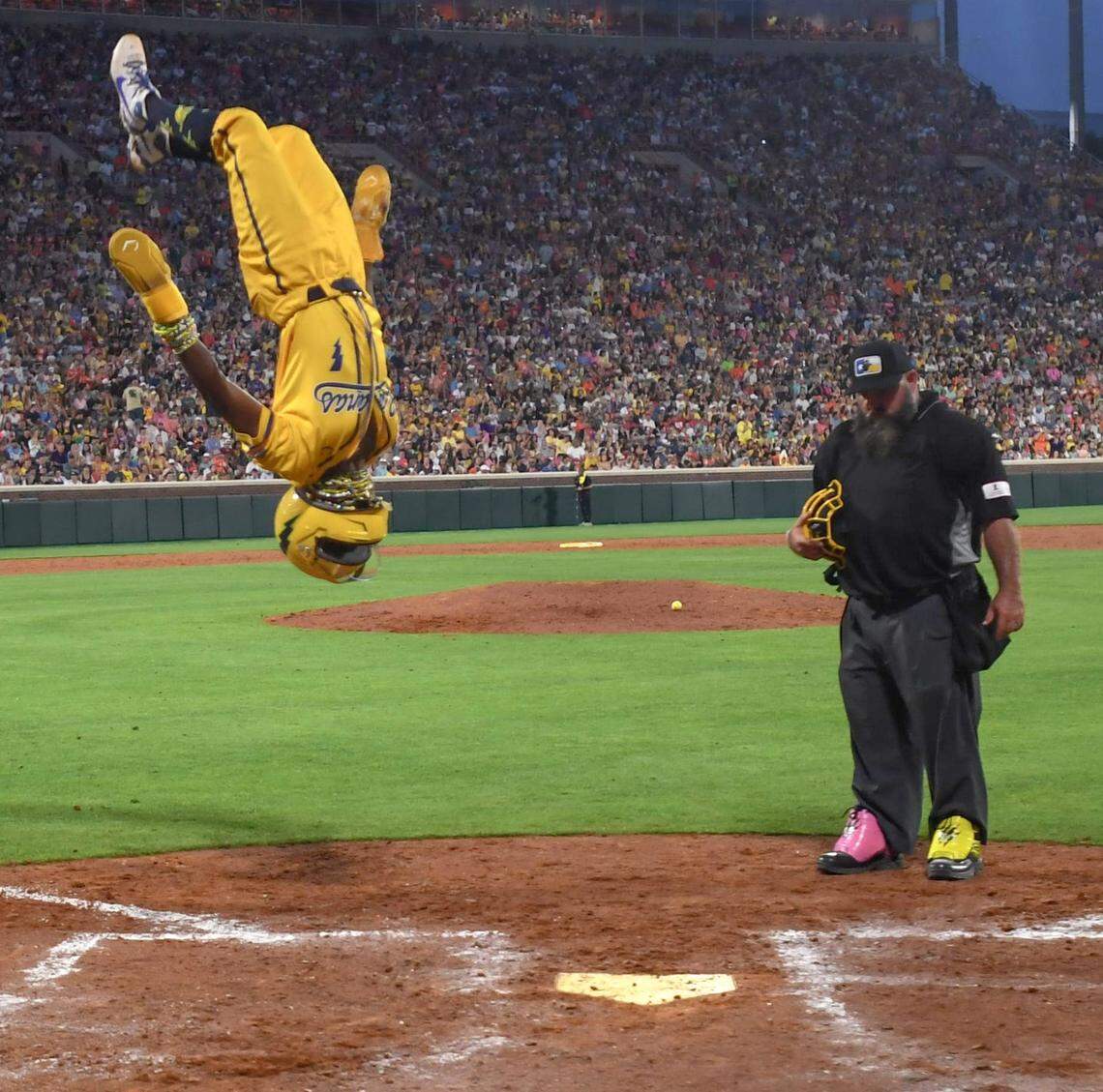 Savannah Bananas dr Malachi Mitchell flips before touching home plate, scoring during the game with the Party Animals at Memorial Stadium in Clemson, S.C. Saturday, April 26, 2025.