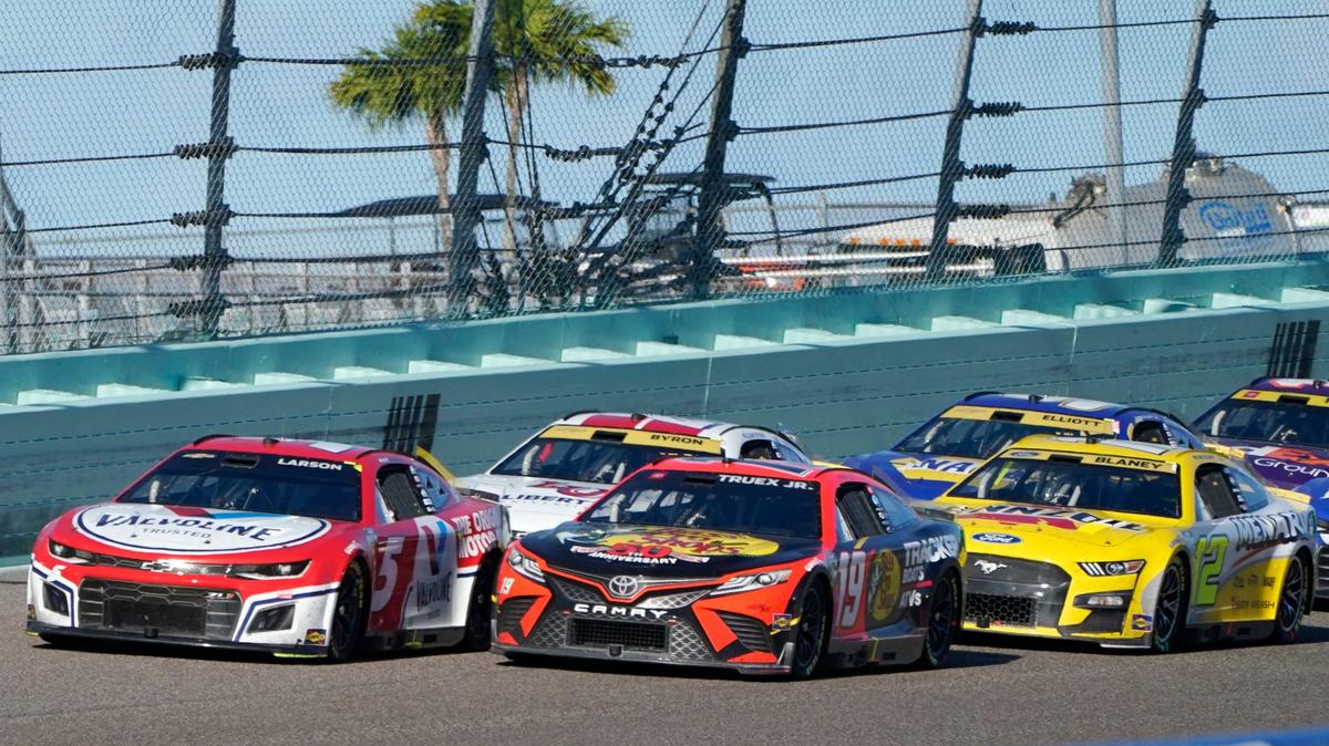 Kyle Larson (5), Martin Truex Jr. (19) and Ryan Blaney (12) approach the start finish line after a yellow caution flag during a NASCAR Cup Series auto race at Homestead-Miami Speedway, Sunday, Oct. 23, 2022, in Homestead, Fla. (AP Photo/Terry Renna)