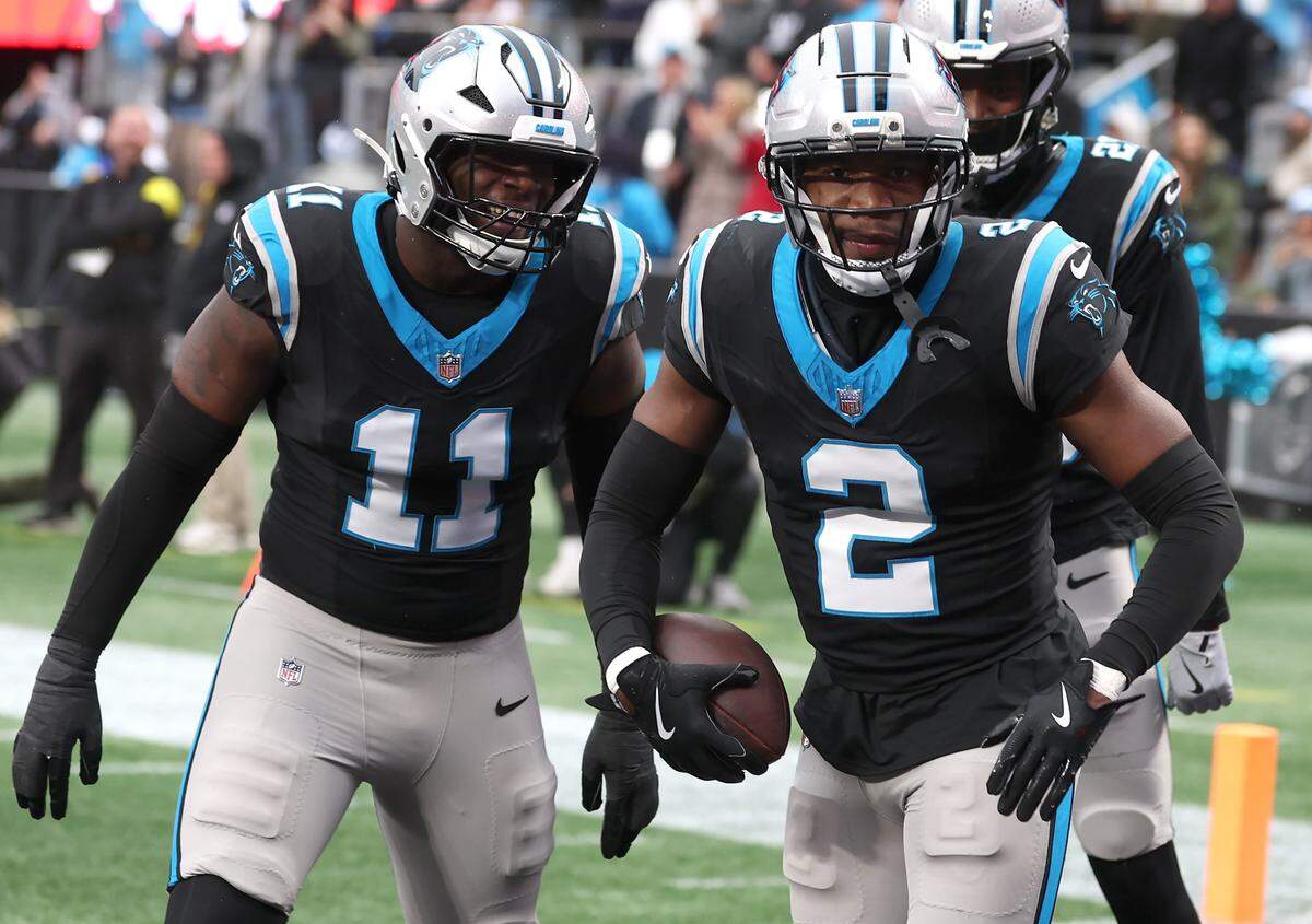 Panthers cornerback Mike Jackson, right, celebrates his interception and touchdown against the Rams. The Panthers beat the Rams 31-28.
