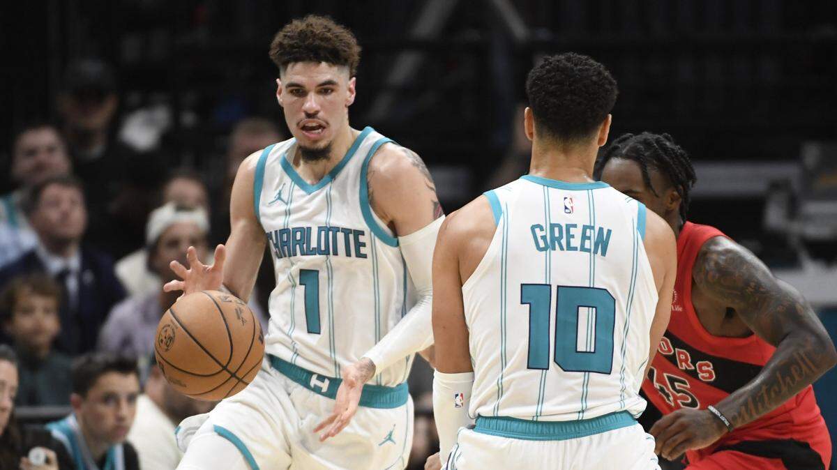 Charlotte Hornets guard LaMelo Ball (1) catches a pass from guard Josh Green (10) during the second half against the Toronto Raptors at the Spectrum Center.