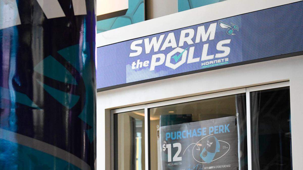 A Swarm the Polls logo is displayed above the concourse inside the Spectrum Center as preparations continued on Wednesday, October 14, 2020 for early voting starting the next day.