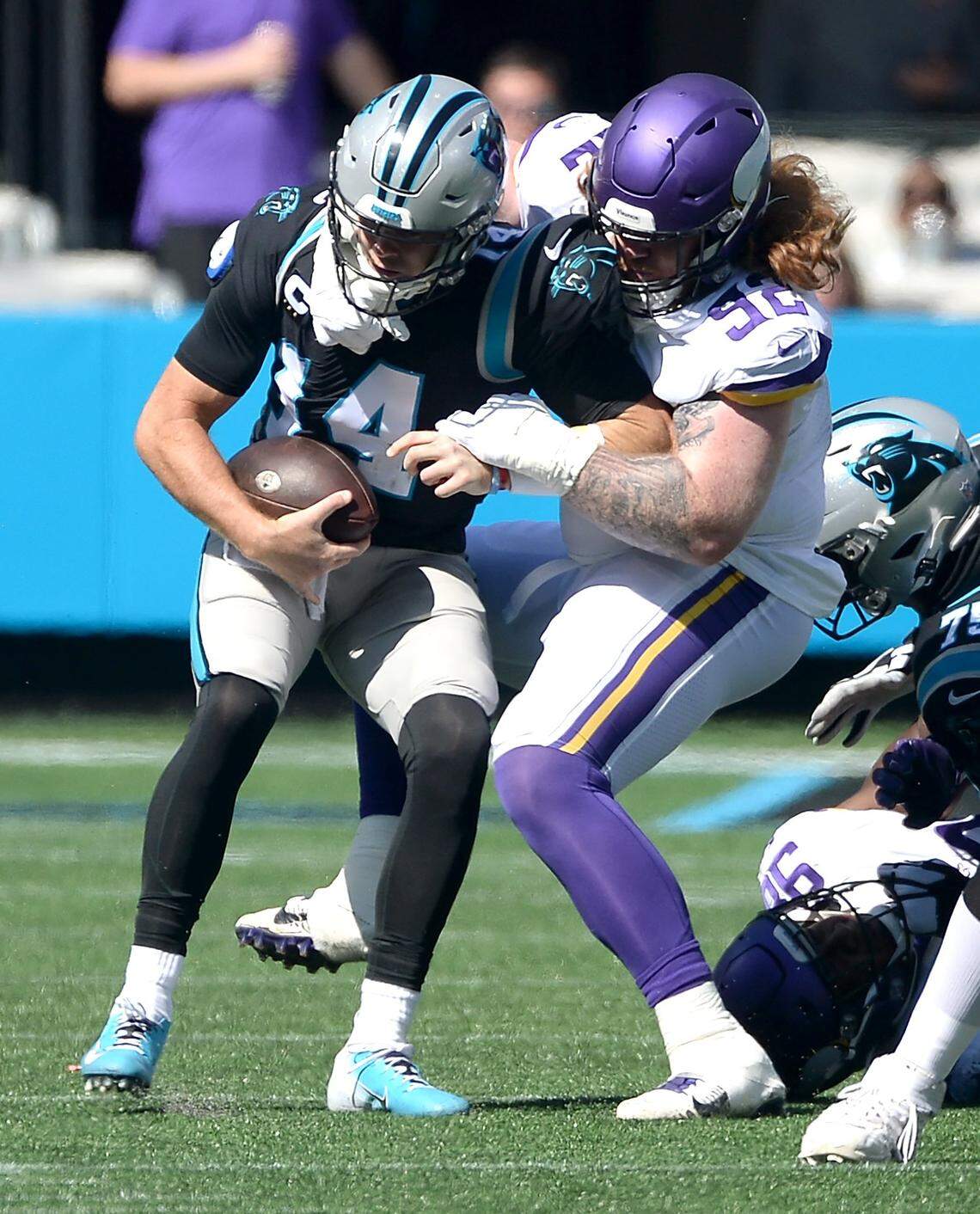 Carolina Panthers quarterback Sam Darnold, left, is sacked by Minnesota Vikings defensive tackle James Lynch in 2021. Darnold began the 2021 season leading the Panthers to a 3-0 record, but the team would finish 5-12.
