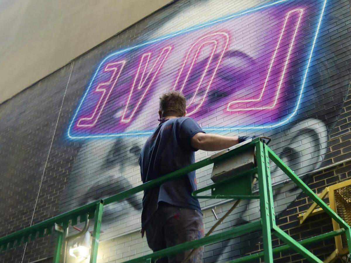 Artist Matt Moore will be creating a special mural at the entrance of Lovin’ Life Music Fest in uptown Charlotte.
