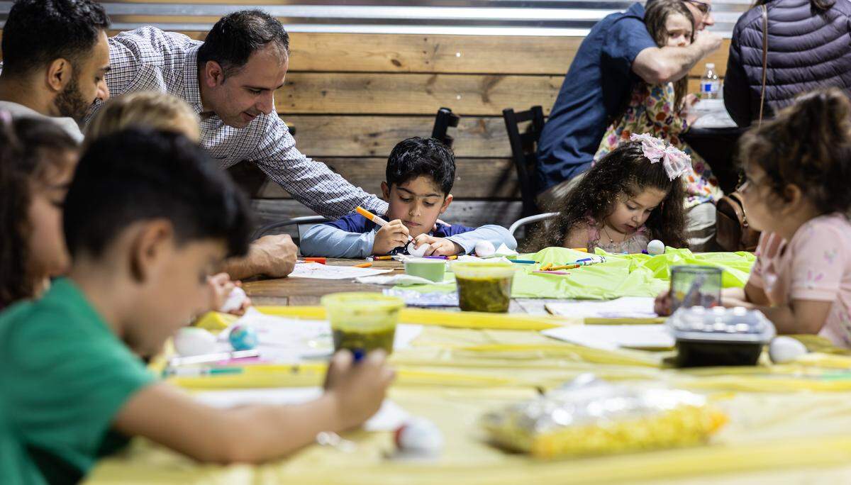 Children decorate eggs during the Nowruz Bazaar in Charlotte on Sunday, March 15.