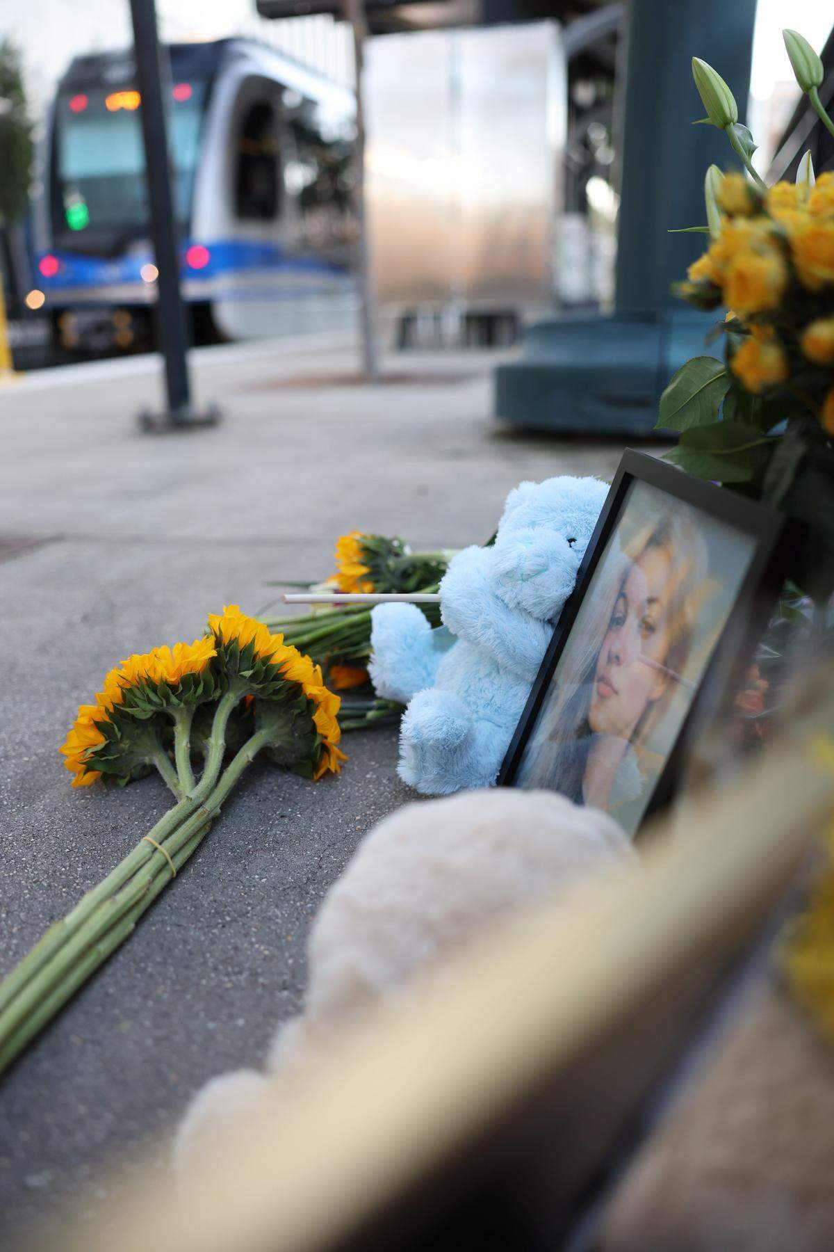 A sign reading "We failed you, Iryna. Rest in peace" hangs above a memorial for Ukranian refugee, Iryna Zarutska, who was fatally stabbed on Charlotte's Lynx Blue Line train.