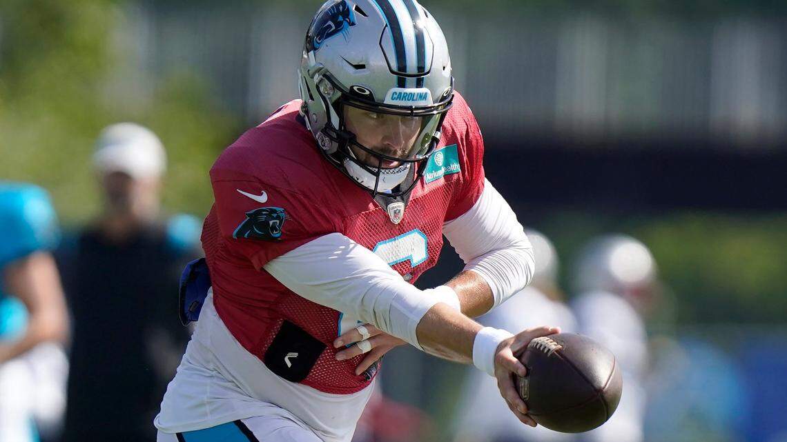 Carolina Panthers quarterback Baker Mayfield prepares to hand off the ball during an NFL football joint practice with the New England Patriots, Tuesday, Aug. 16, 2022, in Foxborough, Mass. (AP Photo/Steven Senne)