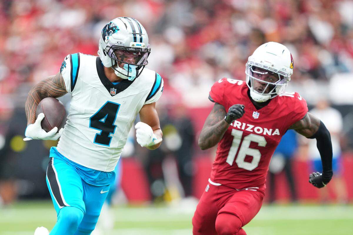 Carolina Panthers wide receiver Tetairoa McMillan (4) runs with the ball during Sunday’s first quarter against Arizona Cardinals cornerback Max Melton (16) at State Farm Stadium.