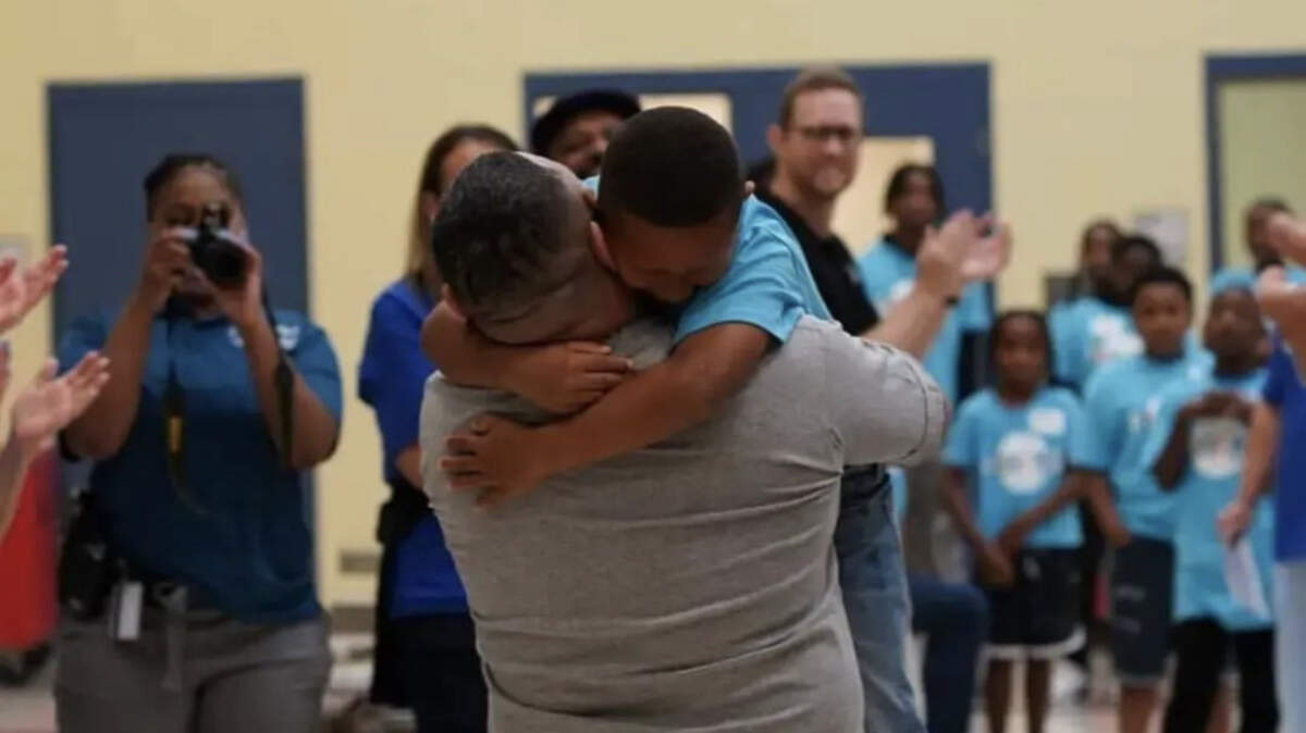 A father reunites with his son during a Proverbs226 prison event at Central Prison in North Carolina. July 2023