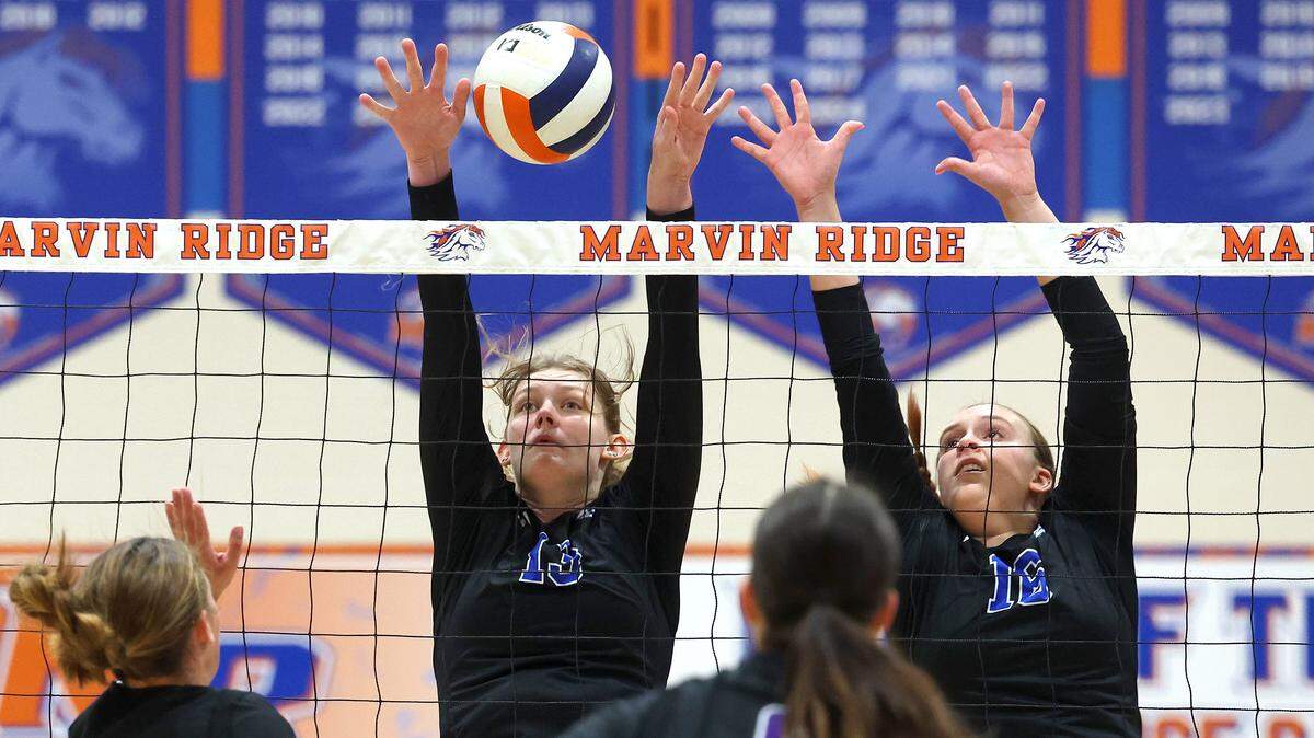 Marvin Ridge High girls volleyball players Natalie Unkrich, left and Lauren Davis, right, look to block a shot over the net by Northern Guilford during NC 4A quarterfinal volleyball playoff action at Marvin Ridge High School on Tuesday, October 29, 2024. Marvin Ridge defeated Northern Guilford 3-0.