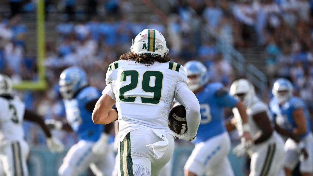 Sep 7, 2024; Chapel Hill, North Carolina, USA; Charlotte 49ers defensive back Maguire Neal (29) runs with the ball after making an interception in the third quarter at Kenan Memorial Stadium.