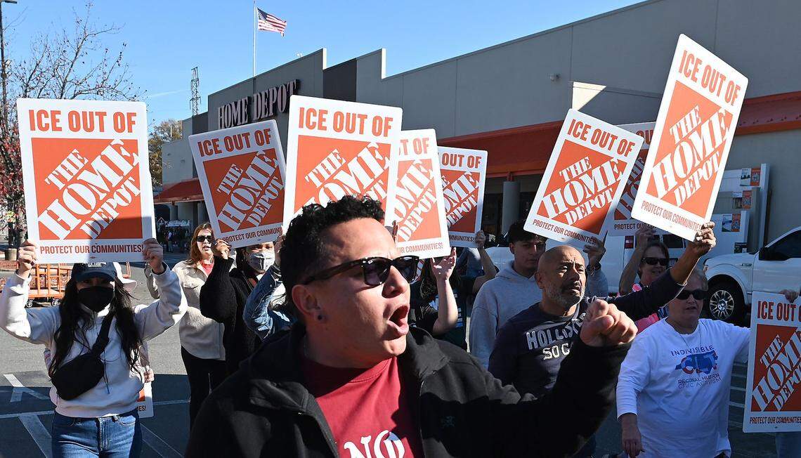 Protesters walk down outside the Home Depot on North Wendover Road in Charlotte, NC on Wednesday, November 19, 2025. 