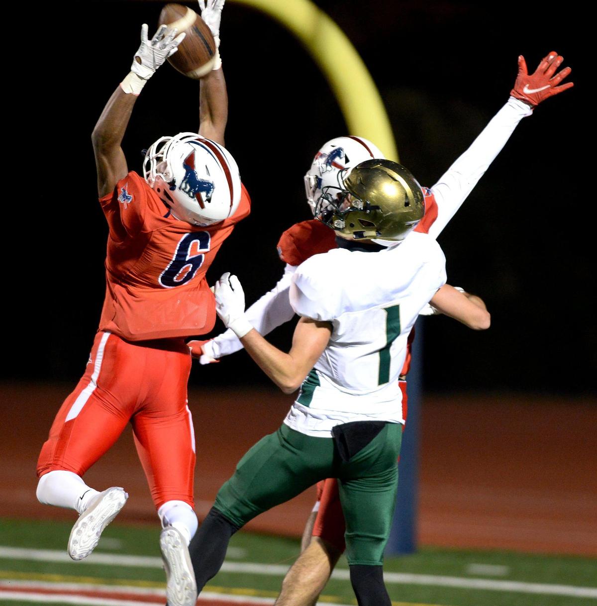 Providence Day Chargers defensive back Braxton Winston, left, breaks up a pass in the end zone meant for Rabun Gap wide receiver Tucker Holloway, right, during first quarter action at Providence Day School in Charlotte, NC on Friday, November 19, 2021. The Chargers hosted Rabun Gap in the NCISAA boys state championship game.