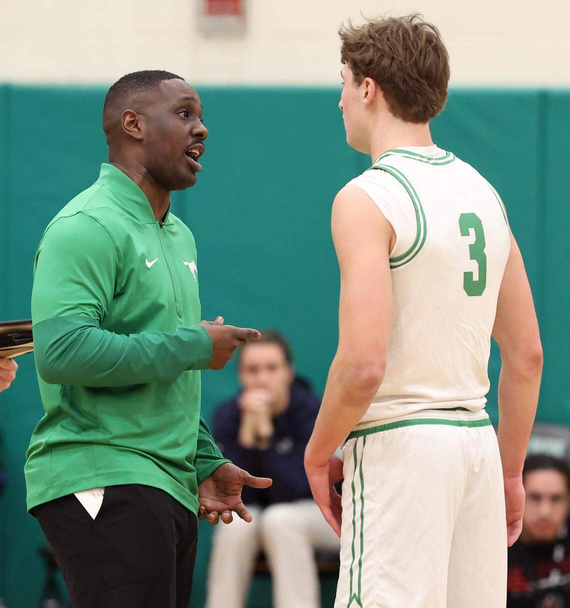 Myers Park Mustangs coach Dorionte Hines, left, speaks with Thomas Vickery, right, during action against the West Meck Hawks on Feb. 6, 2026, at Myers Park High School in Charlotte. West Meck defeated Myers Park 62-59.