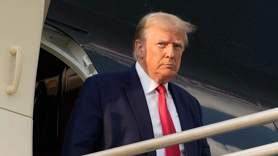 Former President Donald Trump steps off his plane as he arrives at Hartsfield-Jackson Atlanta International Airport, Thursday, Aug. 24, 2023, in Atlanta.