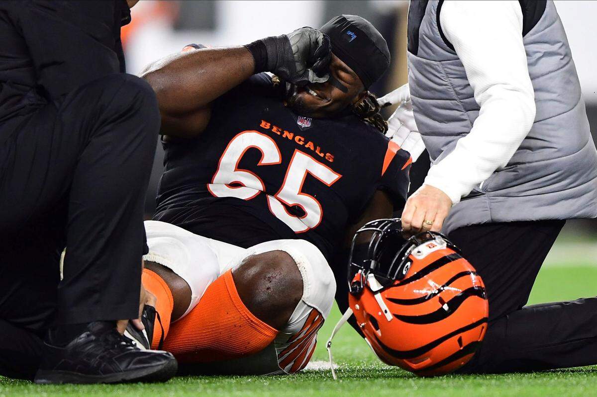 Cincinnati Bengals defensive tackle Larry Ogunjobi (65) reacts after he suffered a foot injury during an NFL wild-card playoff football game against the Las Vegas Raiders on Jan. 15.