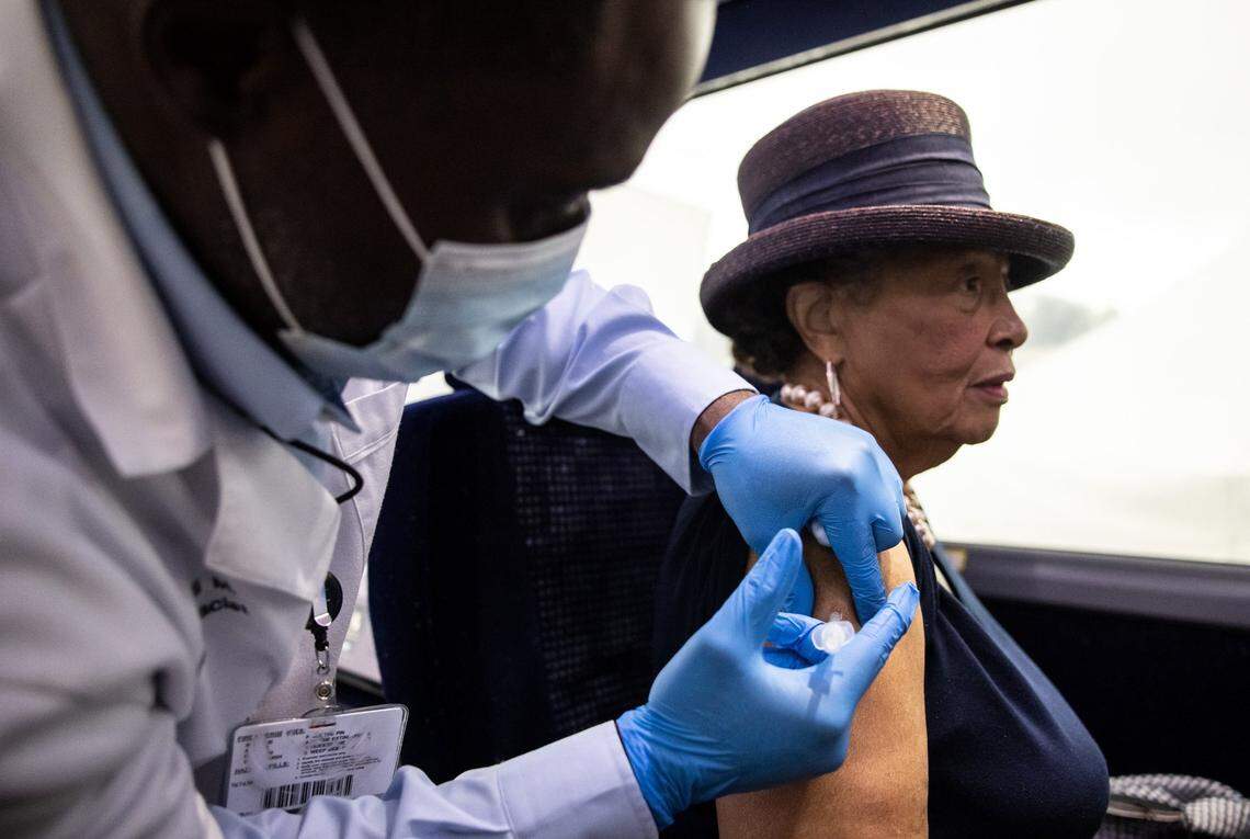 Urundi Moore, left, gives Congresswoman Alma Adams the COVID-19 booster shot at a pop-up vaccination event in Mint Hill on September 1, 2021.