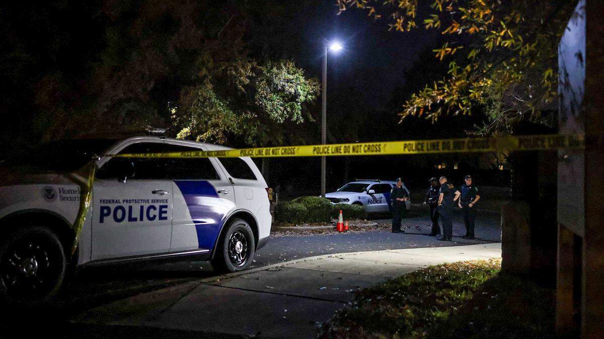 Officers stand outside the Department of Homeland Security/ICE headquarters on Tyvola Centre Drive as protesters gather to voice their concern over  Border Patrol in Charlotte on Nov. 16. 
