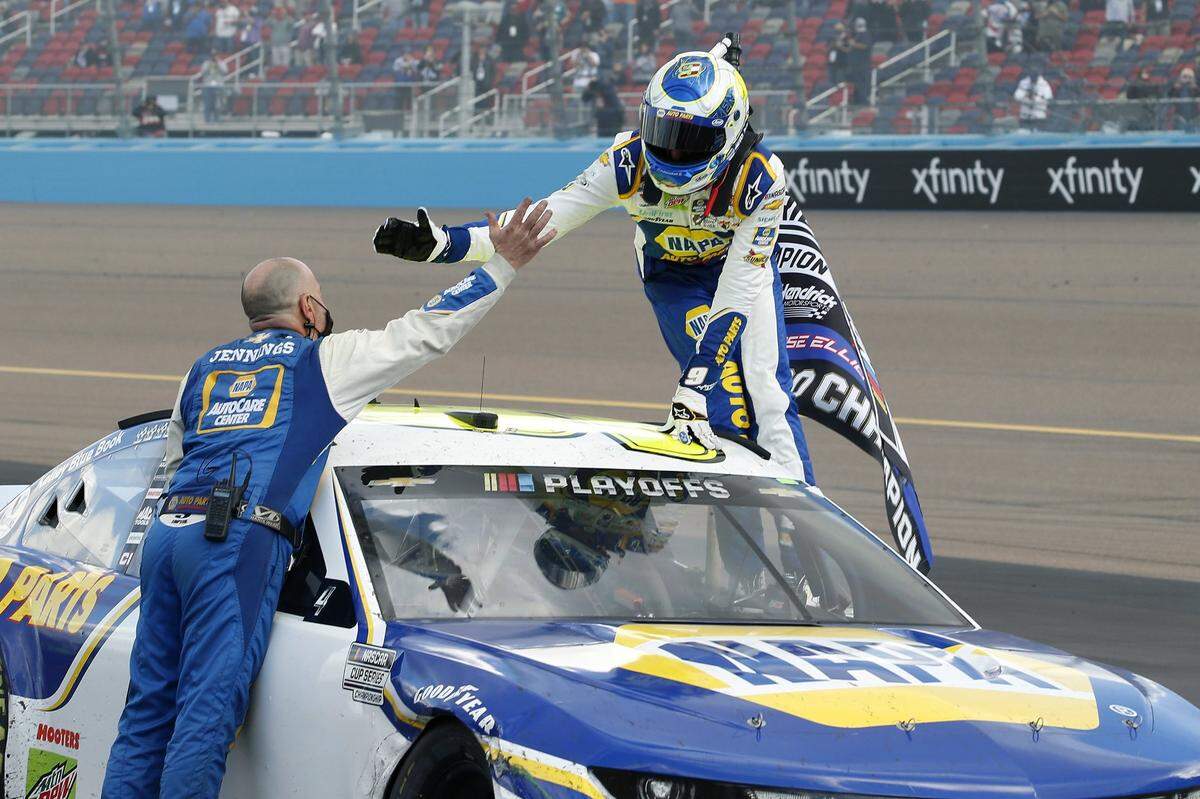 Chase Elliott, right, celebrates with a pit crew member following his season championship victory in the NASCAR Cup Series auto race at Phoenix Raceway, Sunday, Nov. 8, 2020, in Avondale, Ariz. (AP Photo/Ralph Freso)