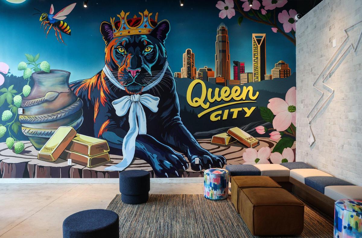 Several murals that celebrate the Queen City are part of the decor of the Moxy Charlotte Downtown. This mural greets guests at the entrance and incorporates a panther, a hornet, the city skyline and gold bars as a nod to Charlotte’s past and present.