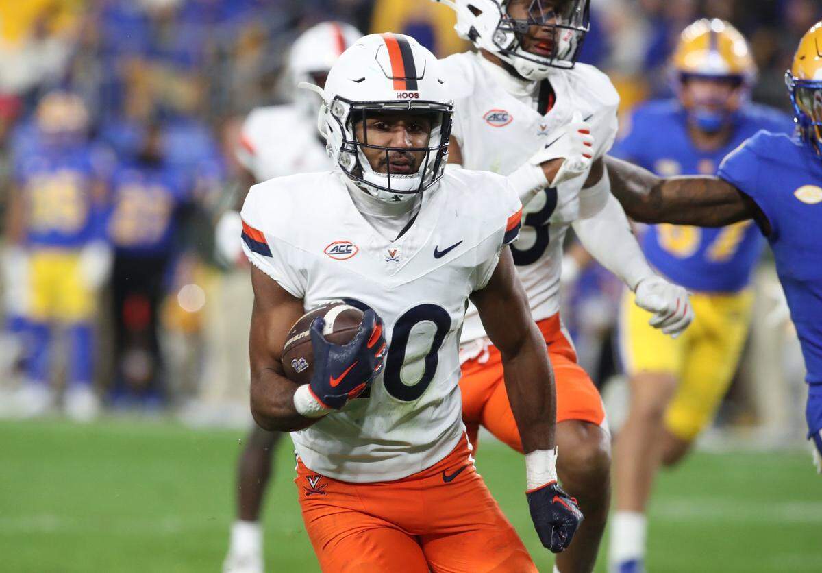 Nov 9, 2024; Pittsburgh, Pennsylvania, USA;  Virginia Cavaliers safety Jonas Sanker (20) returns an interception against the Pittsburgh Panthers during the third quarter at Acrisure Stadium. Mandatory Credit: Charles LeClaire-Imagn Images