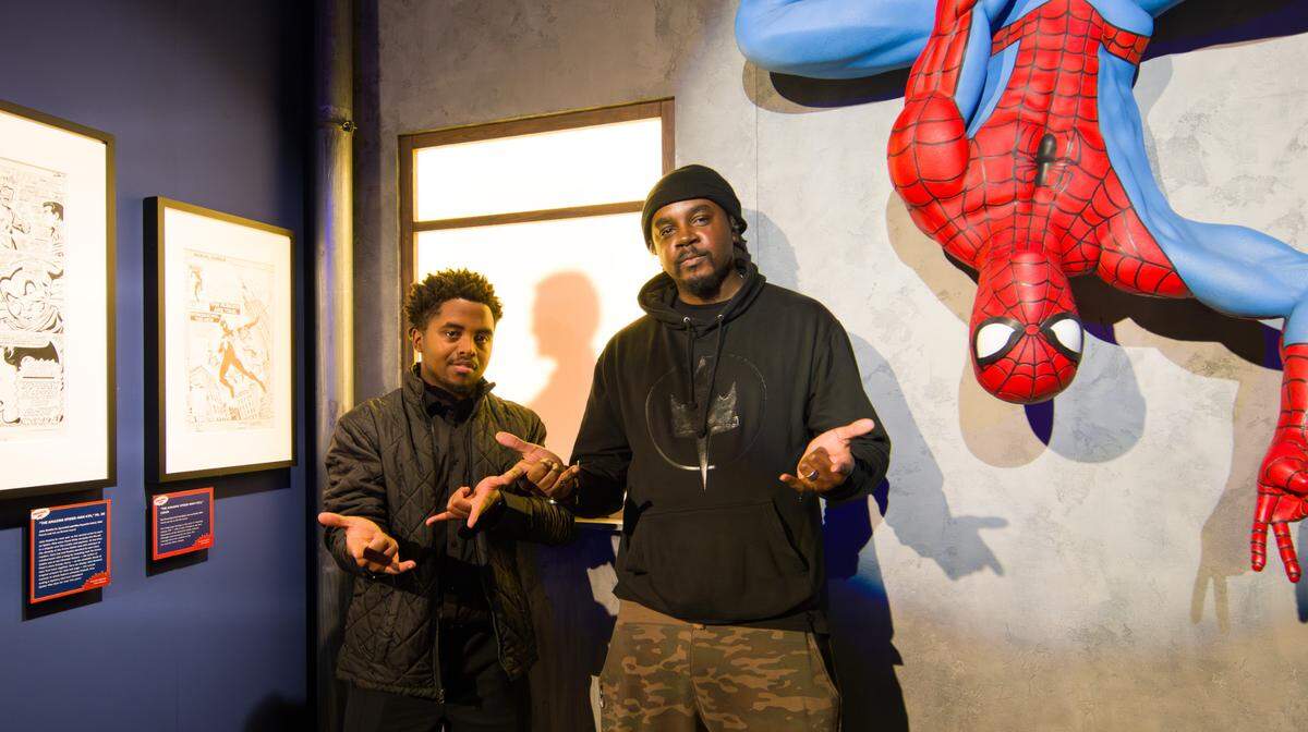 Charlotte graphic novelist Wolly McNair compares Spider-Man technique with student journalist and aspiring artist Devonte Thomas.