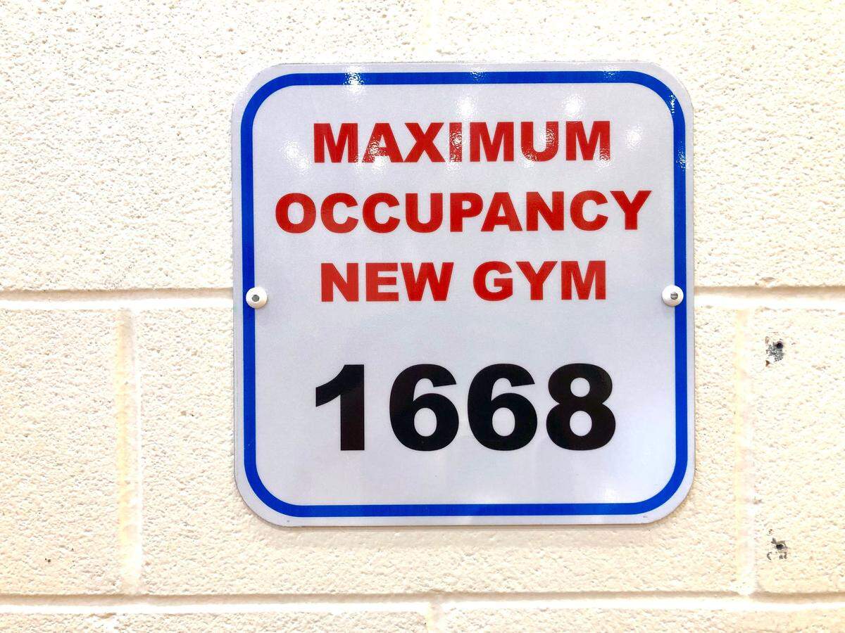 A sign hanging in Myers Park’s gym shows the maximum allowed capacity. The gym was sold out in seconds for last week’s Myers Park-North Mecklenburg state quarterfinal