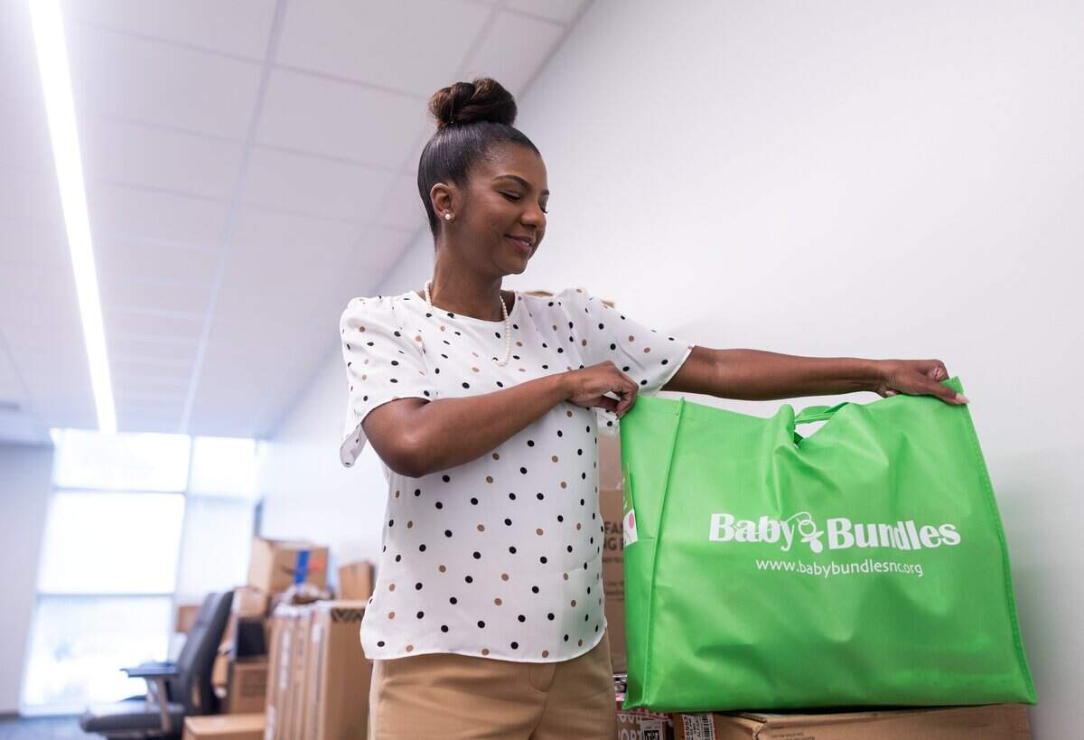 Tchernavia Montgomery shows an example of a Baby Bundles bag with supplies for mothers at Care Ring in Charlotte, N.C., on Wednesday, August 13, 2025.