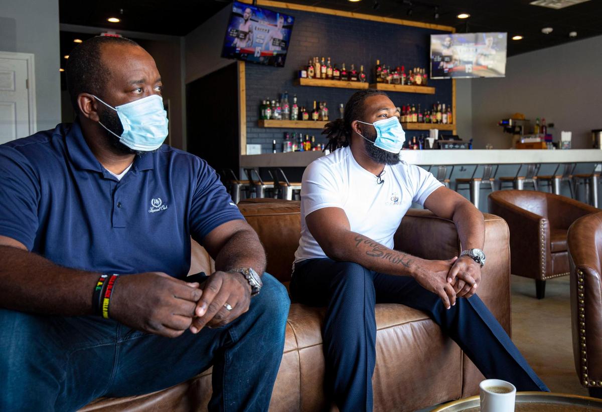 Co-owners Marcus Samuel, left, and Xavian Seiferth, right, talk about the newly opened Sticks and Beans in Concord on July 22, 2020. The store offers coffee and cigars throughout the day, as well as a bar and small plates.