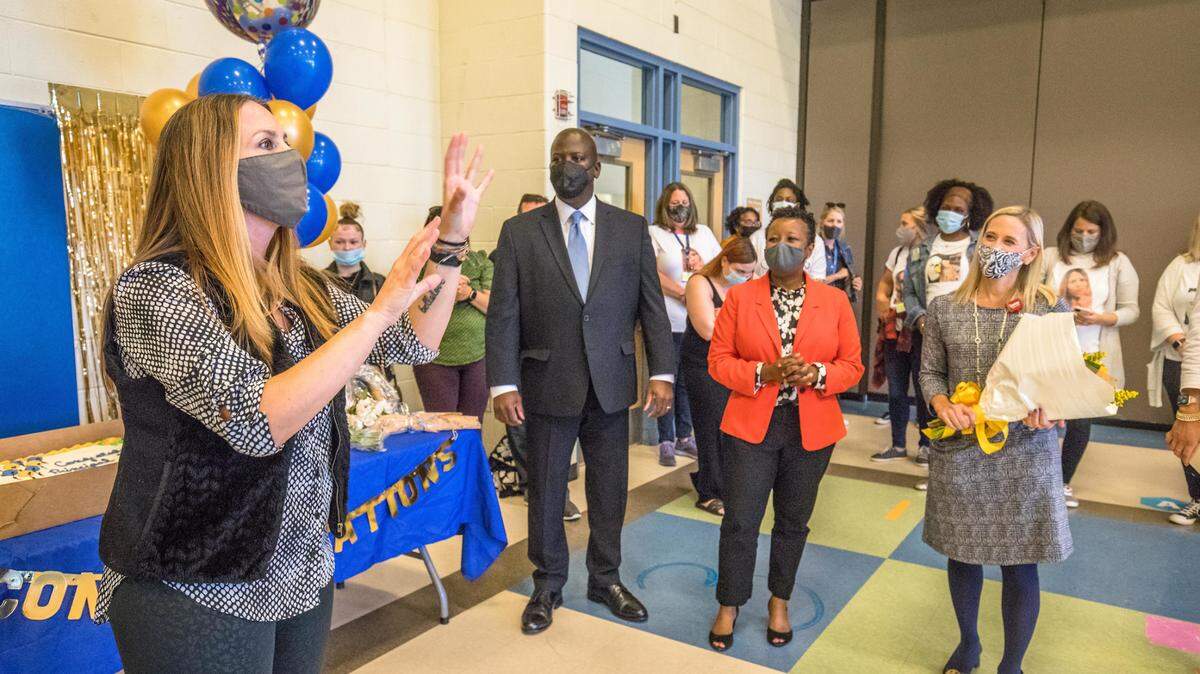 Idlewild Elementary Principal Larenda Denien (left) was given a surprise announcement that she is awarded CMS Principal Of the Year by Superintendent Earnest Winston (center), her faculty, and students.