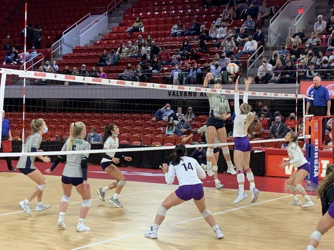 A Green Level High School player attempts a spike in the November state championship. Citing the rise in COVID cases, Wake County si still requiring student-athletes to wear face masks indoors.