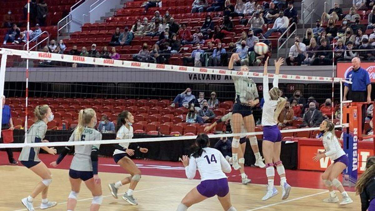 A Green Level player attempts a spike in Saturday’s state championship