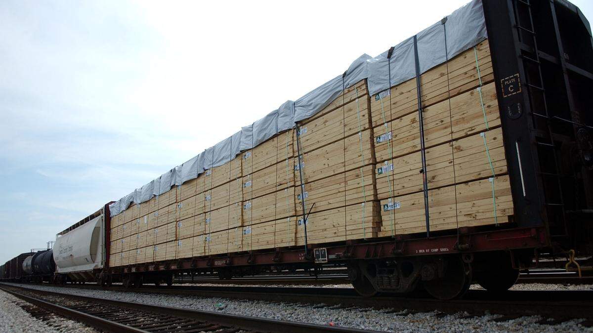 A rail car loaded with lumber sits in a rail yard in Jackson, MIss., Monday, Aug. 16, 2004. Lumber prices have surged during the coronavirus pandemic. (AP Photo/Rogelio Solis)