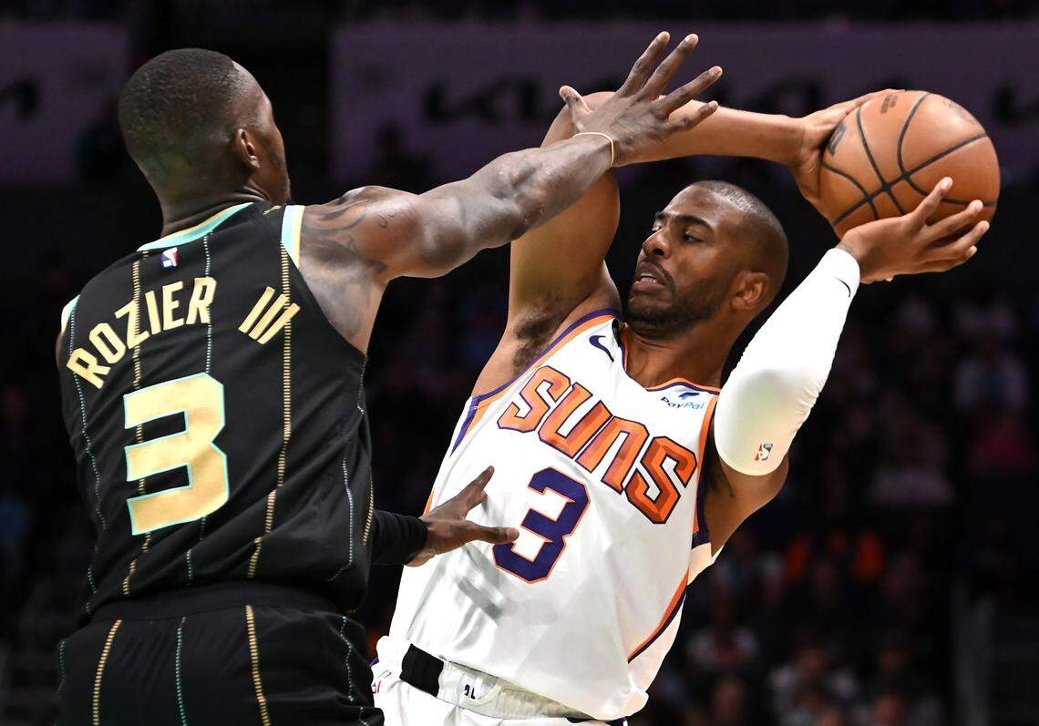 Former Wake Forest University and current NBA star Chris Paul, right, looks to pass to a teammate as Charlotte Hornets guard Terry Rozier, left, applies defensive pressure during NBA action on Wednesday, March 1, 2023 at Spectrum Center in Charlotte, NC. Paul has written a new book titled Sixty-One.