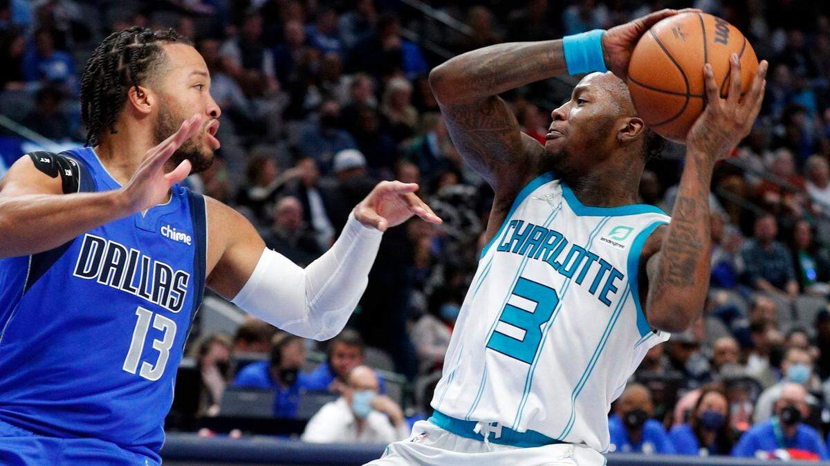 Dallas Mavericks guard Jalen Brunson (13) defends as Charlotte Hornets guard Terry Rozier (3) looks for an open teammate in the second half of an NBA basketball game Monday, Dec. 13, 2021, in Dallas. (AP Photo/Richard W. Rodriguez)