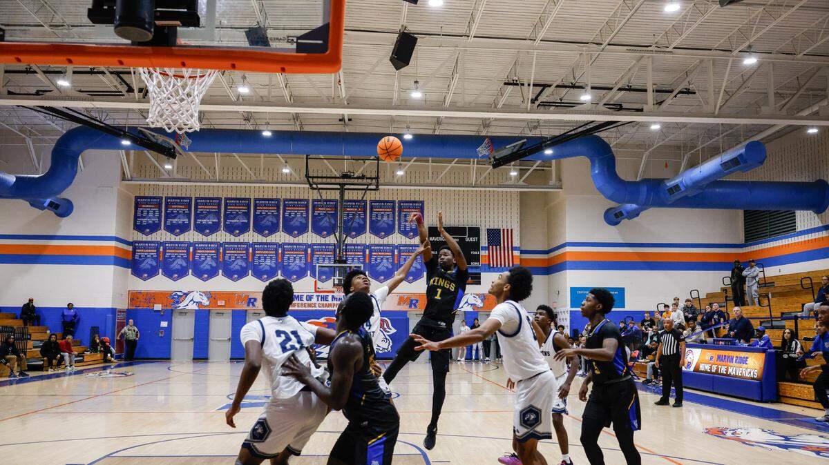 Victory Christian’s Christian Petty, center, shoots for two points from the field, giving Victory Christian a one-point win over Queens Grant during Phenom Hoops’ New Year’s Eve Bash championship game at Marvin Ridge High School on Monday, December 30, 2024.