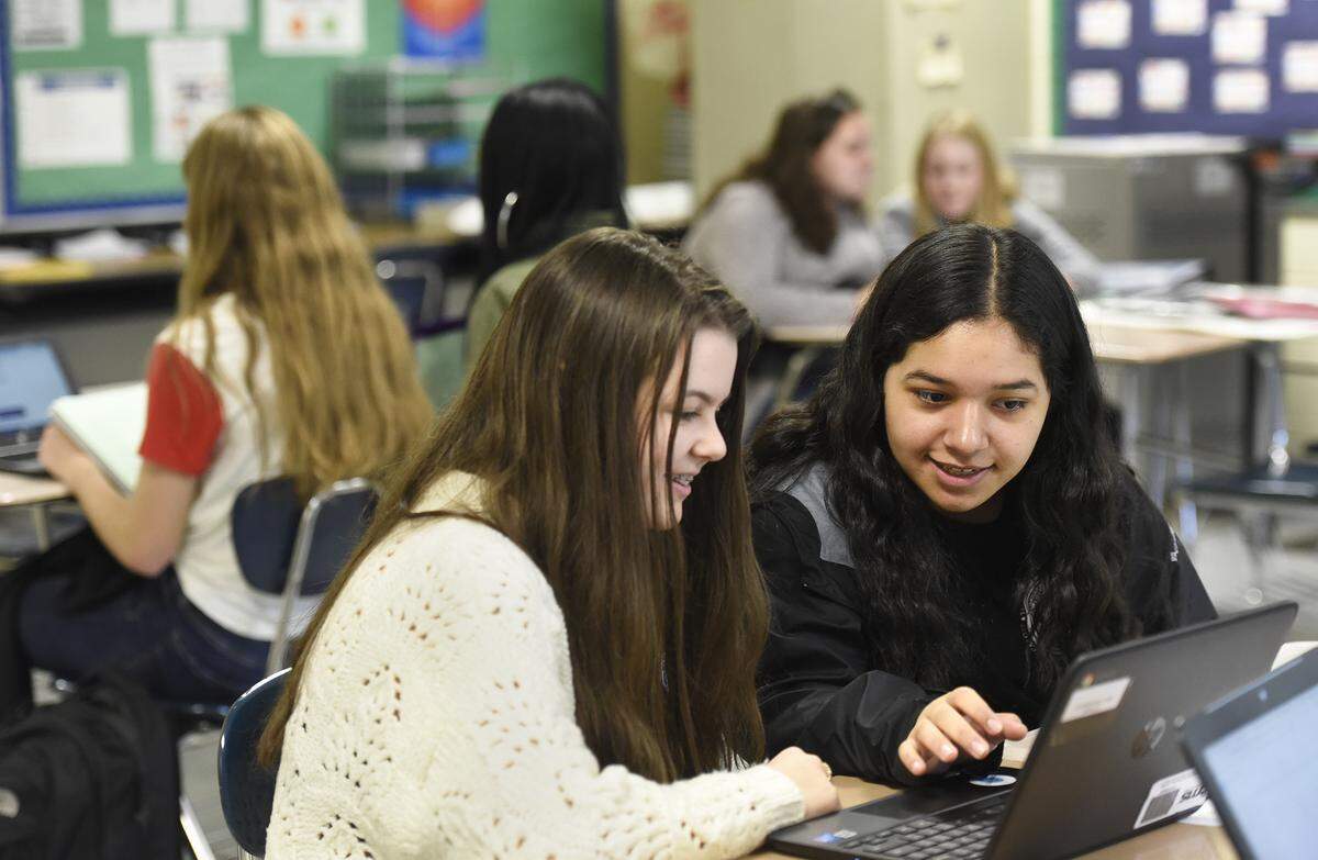 Gabrielle Griffin, 14 and Katie Martinez, 14, collaborate on a health and wellness project in Spanish Two at Hopewell High School. Hopewell High and its feeder schools are piloting the Cambridge program, a British curriculum that emphasizes real-life projects and lots of writing. North Carolina’s only Cambridge schools are in the Charlotte area.